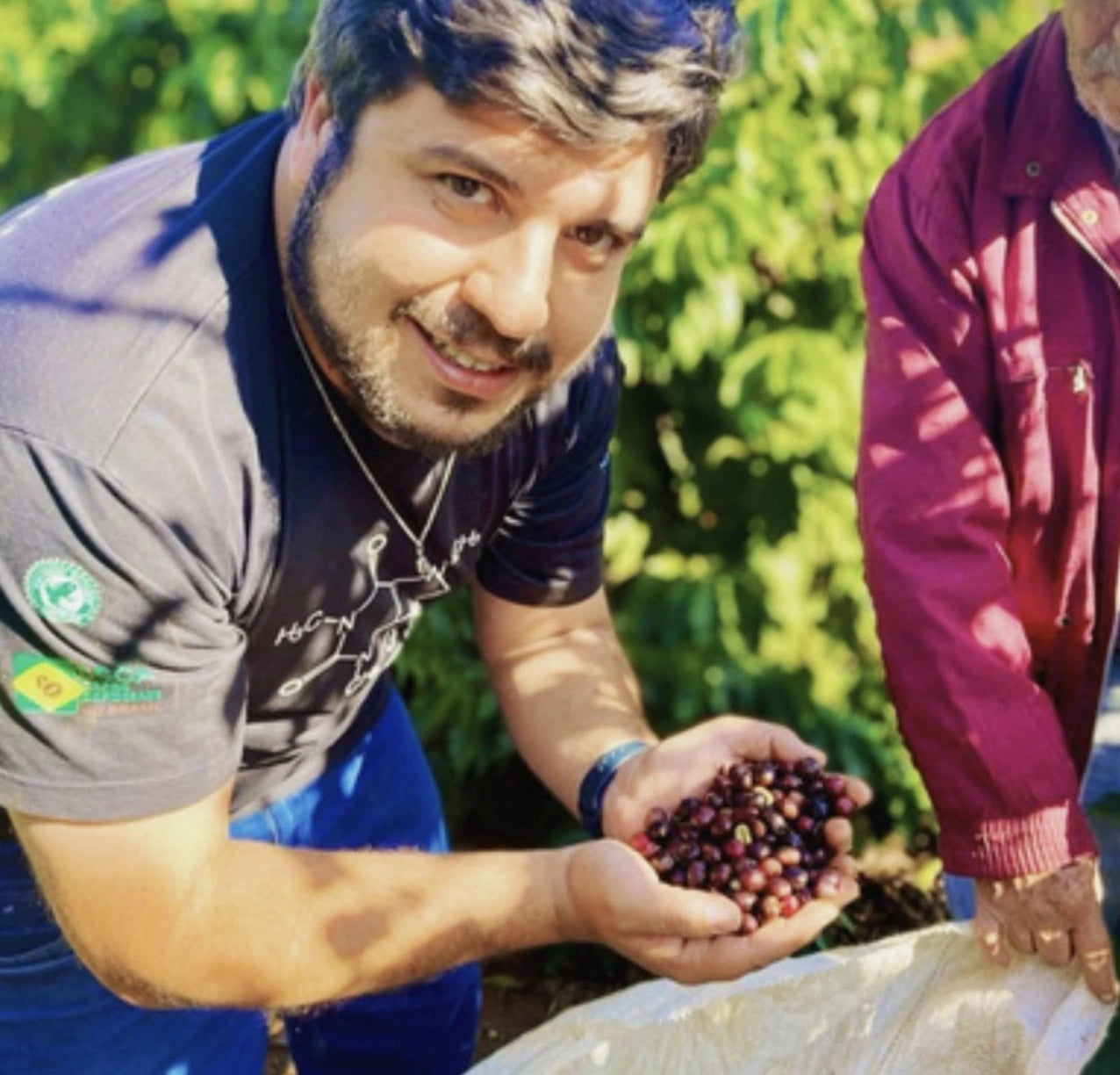 Brazilian coffee producer Deyvid Leandro holding freshly harvested Red Catuai coffee cherries on his farm in Cerrado Mineiro, Brazil - part of Origin Hill Coffee Roasters’ signature collection roasted in Toronto